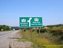 HWY 17 #1062 - © Cameron Bevers: A close-up view of a large aluminum guide sign, which reads Hwy 11 Beardmore Cochrane and Hwy 17 White River Sault Ste Marie