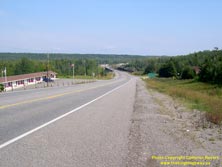 HWY 17 #1069 - © Cameron Bevers: An angled side view of Hwy 11 and Hwy 17 at a long sweeping curve with a motel visible at left and the Nipigon River Bridge in the distance